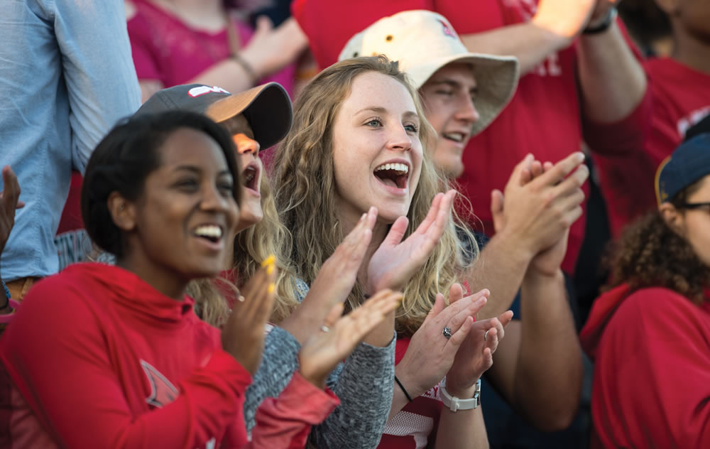 Students cheering at football game