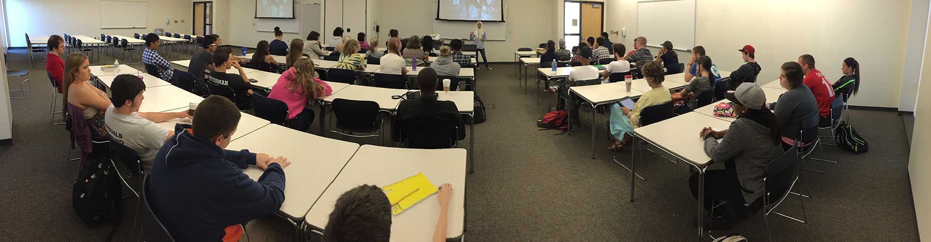 Students listening to a speaker in class