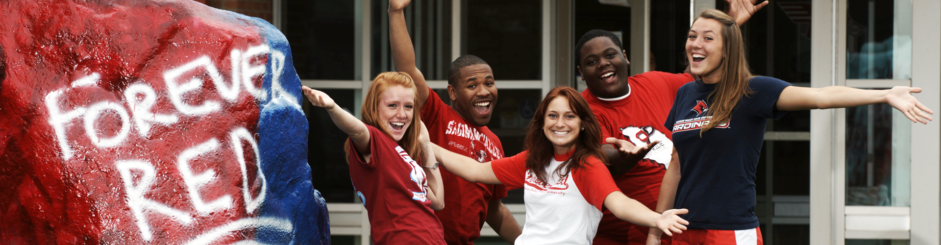 A group of students next to the Rock, with 