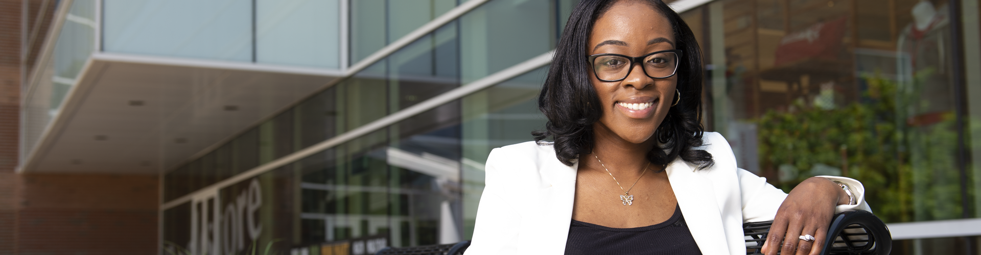 Student sitting on a bench on campus