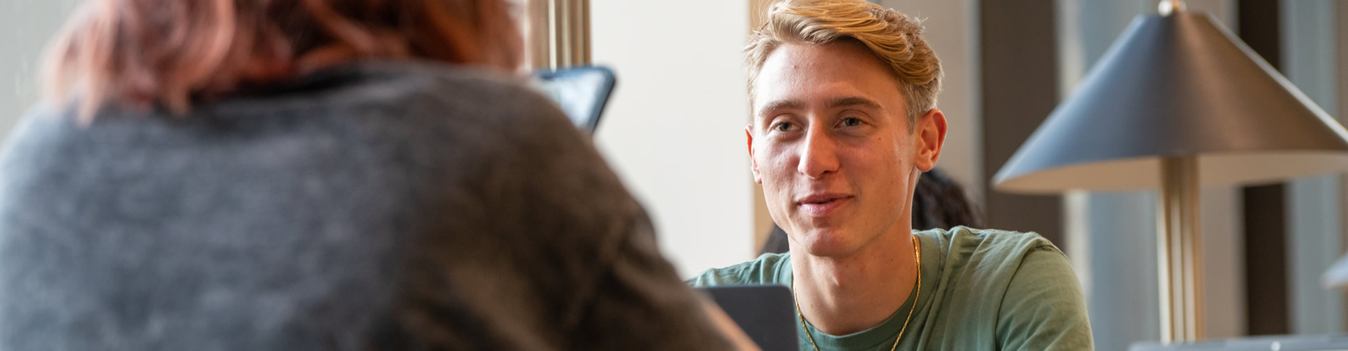 Male student talking to another student