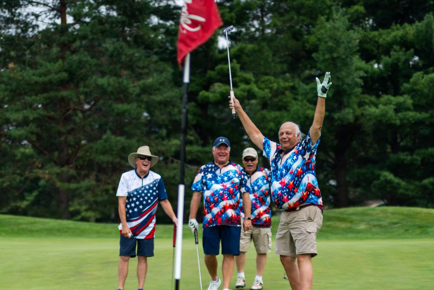 four golfers celebrating at the Cardinal Legacy Golf Outing