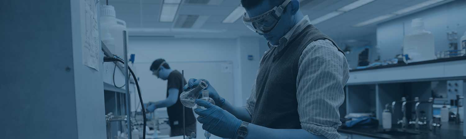 Student mixing chemicals in a lab