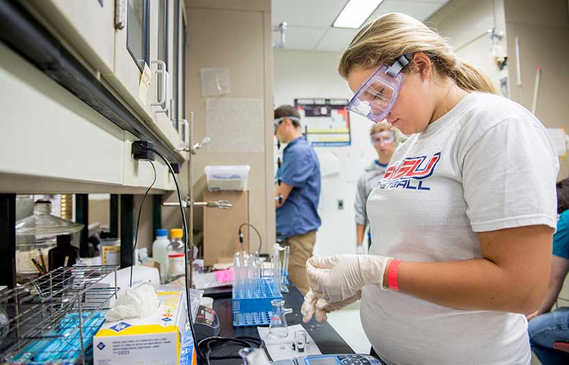 A female is inside a chemistry lab conducting tests for the SSEC. 