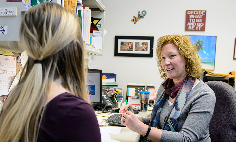 adviser helping student