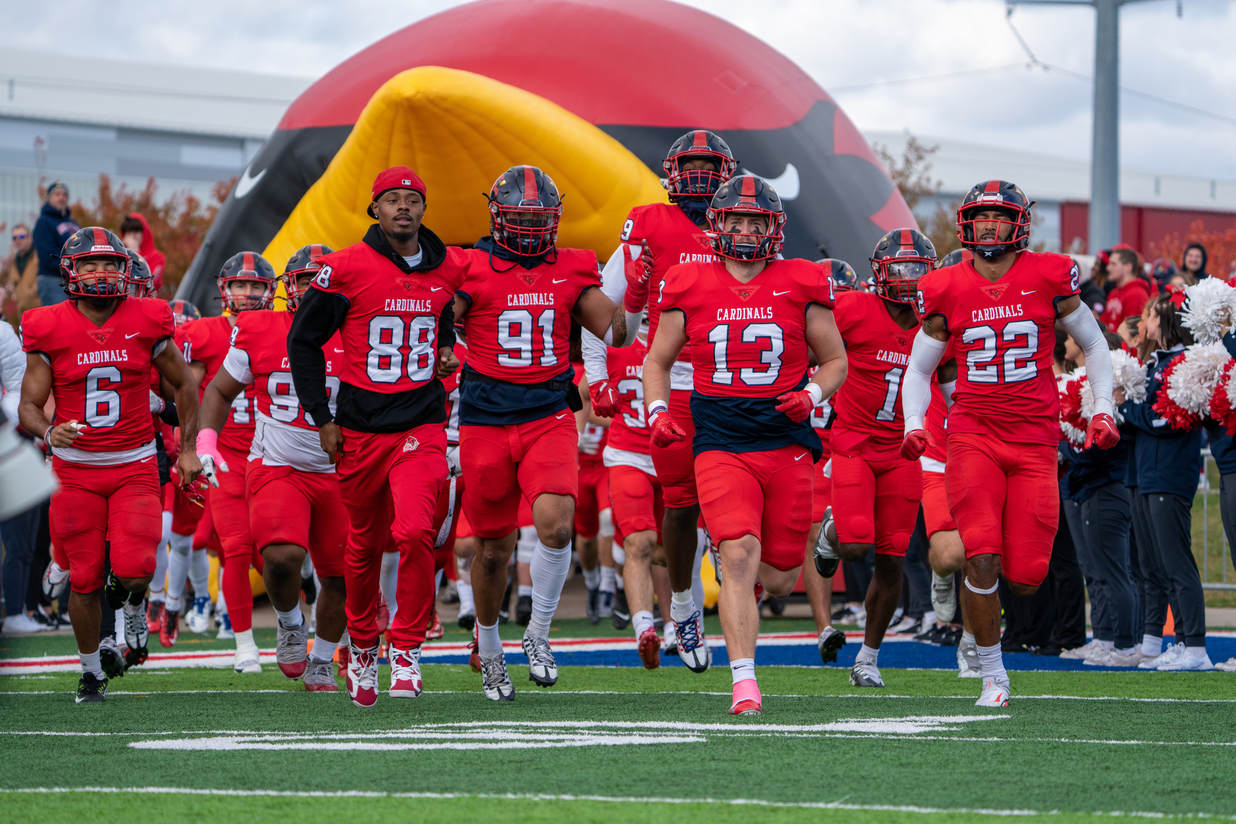 football players entering field