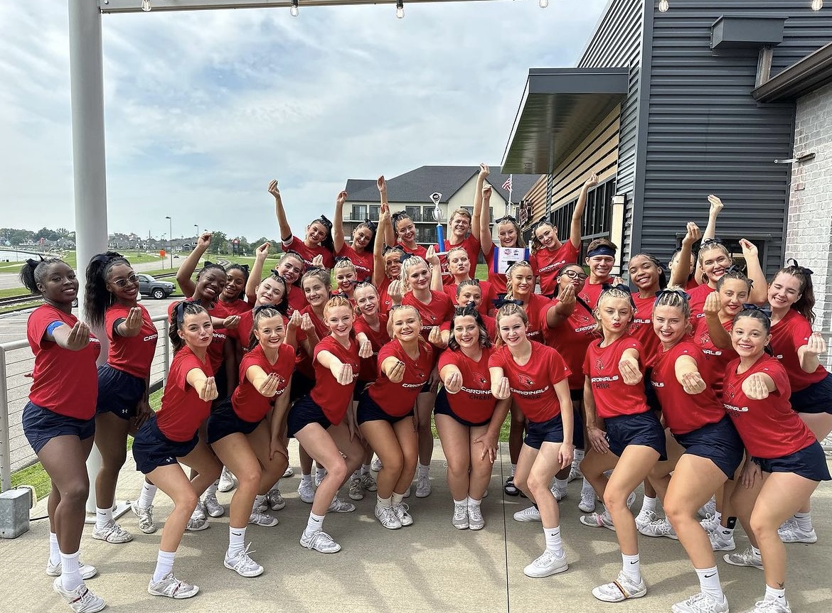Womens cheer holding trophy