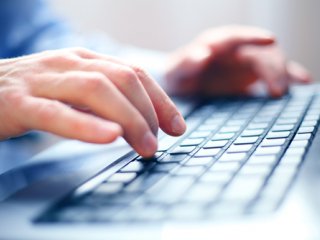 A student typing on a keyboard