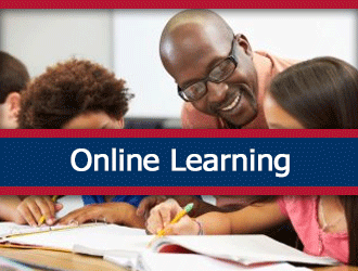 A teacher smiles while helping two young students at a table. A ribbon that says 