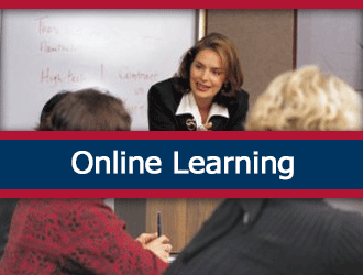 A classroom of adult learners listening to their teacher. A ribbon that says 