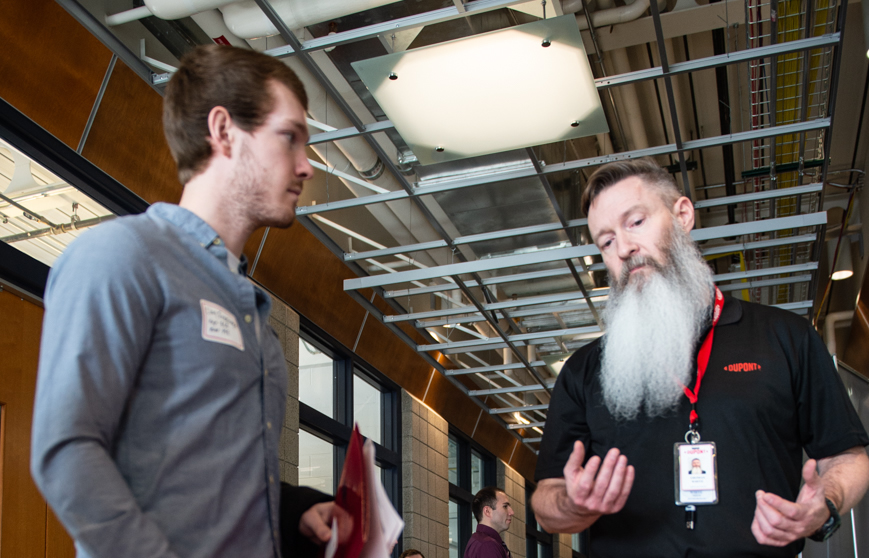 Student talking to business owner