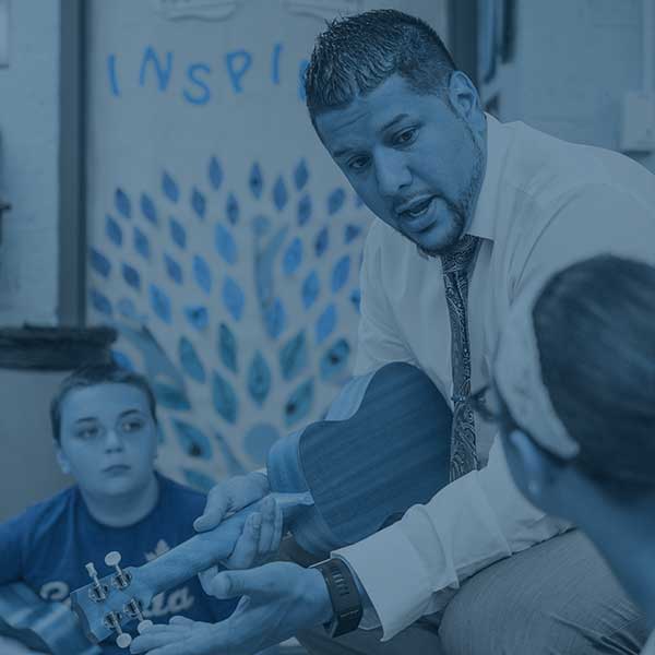 Student teacher in music class with students