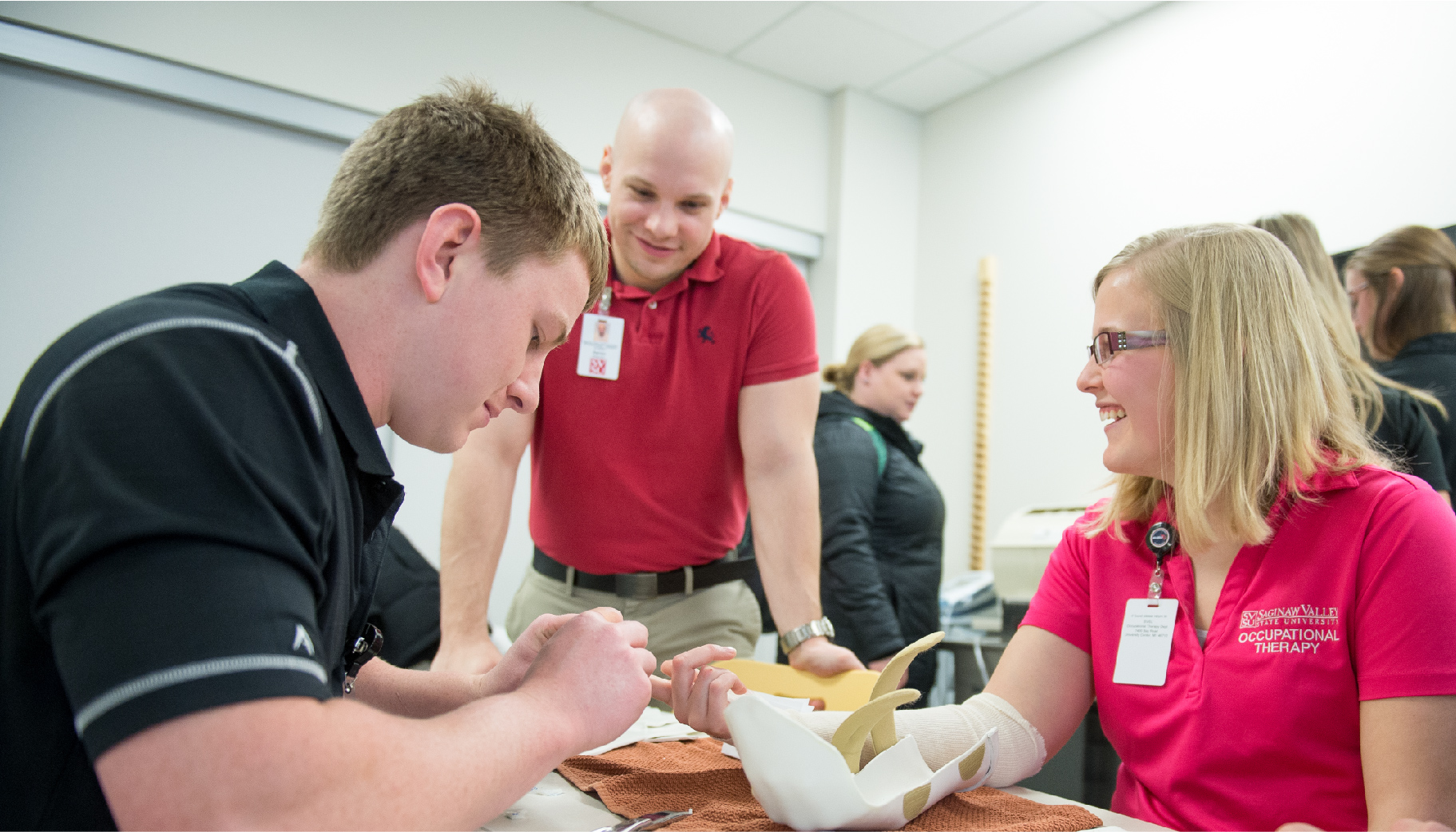 Three adults talking in a group