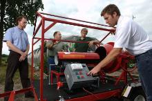 Faculty work on a greenhouse project.
