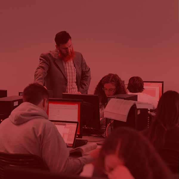 Students and professor working together in class