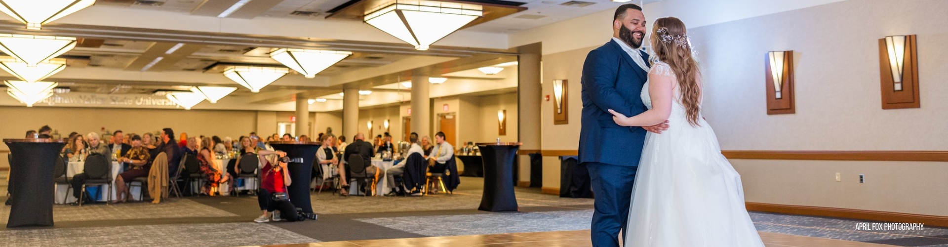 bride and groom dancing while seated guests look on