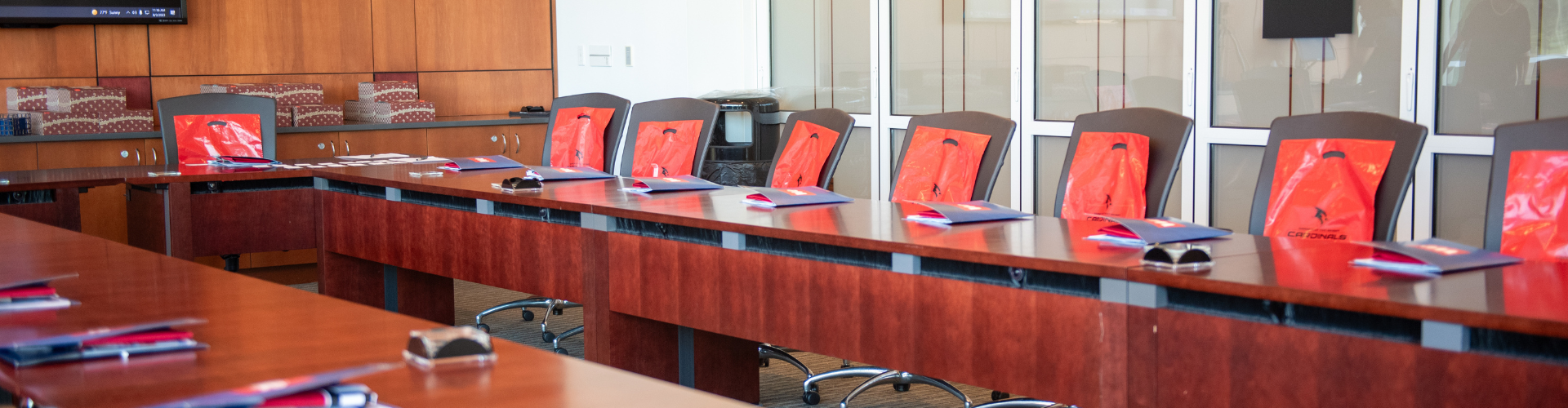 empty board room table with gift bags arranged on chairs