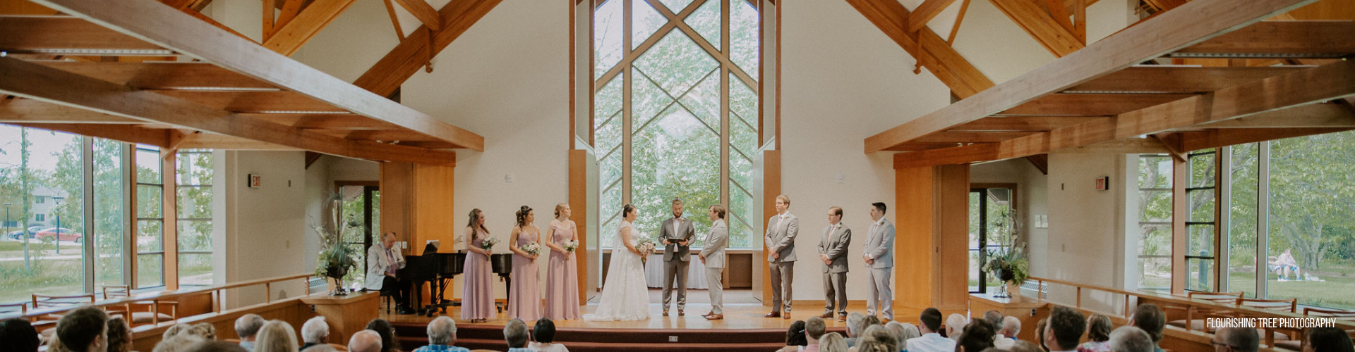couple getting married in front of a large window