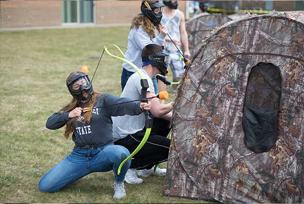 student doing archery in the UV lots