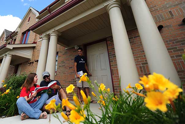 International students working on homework outside