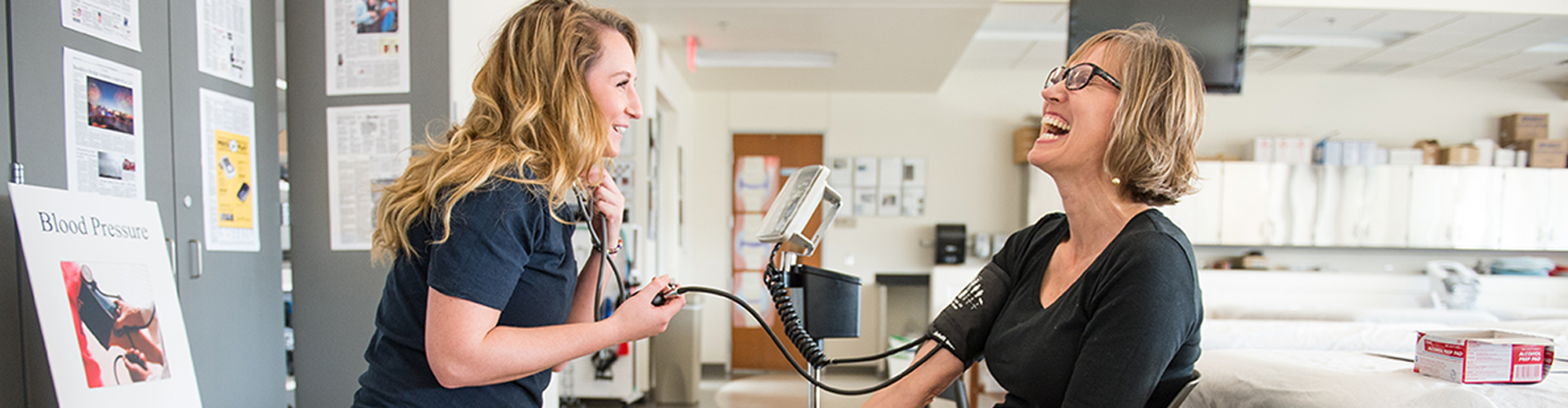 person getting their blood pressure taken by a student 