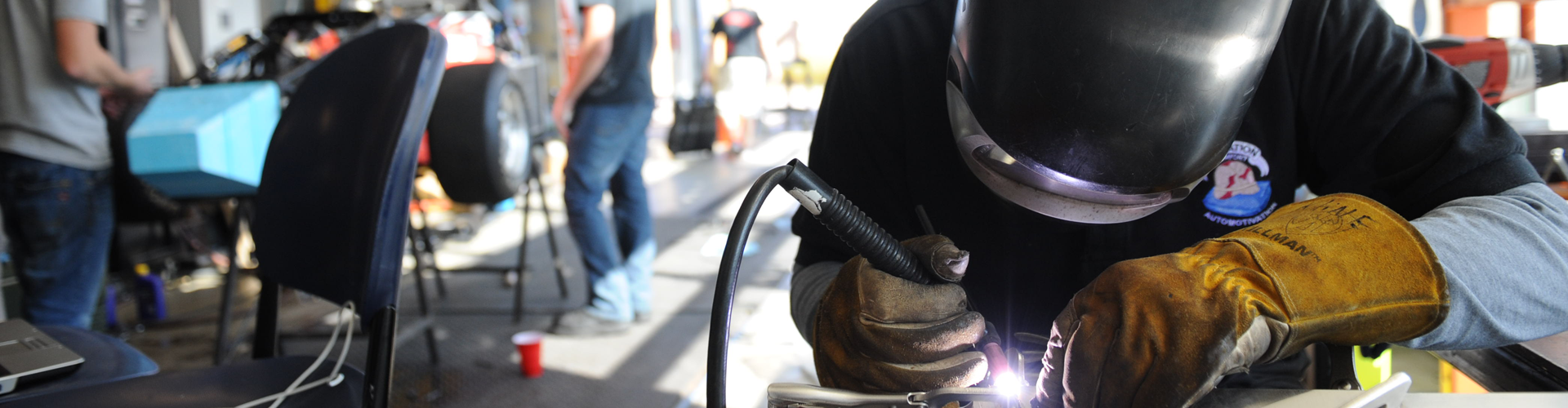 Person in a welding mask welding a project