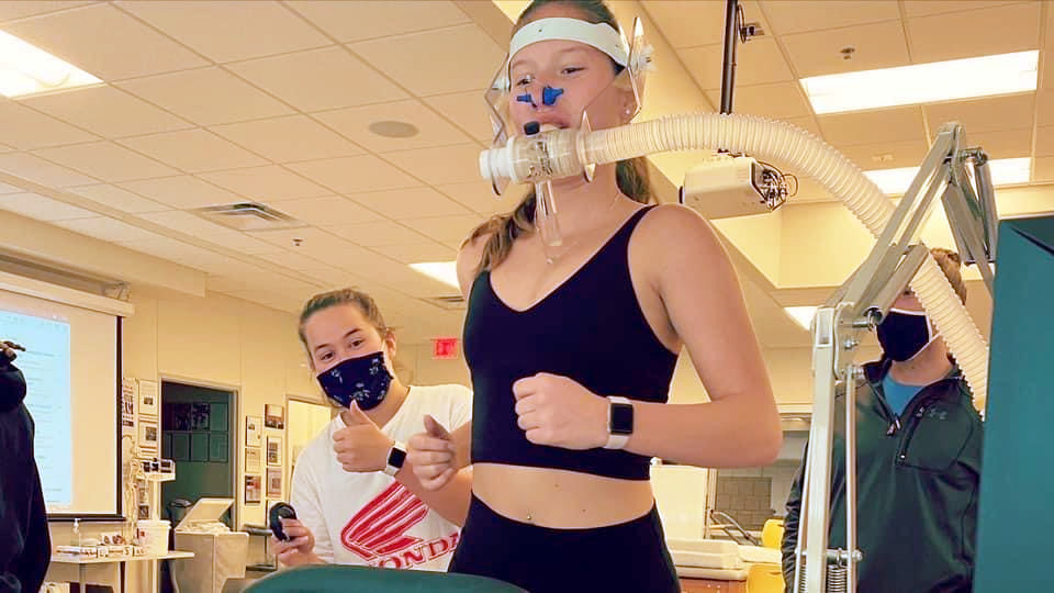 Student on treadmill with second student monitoring