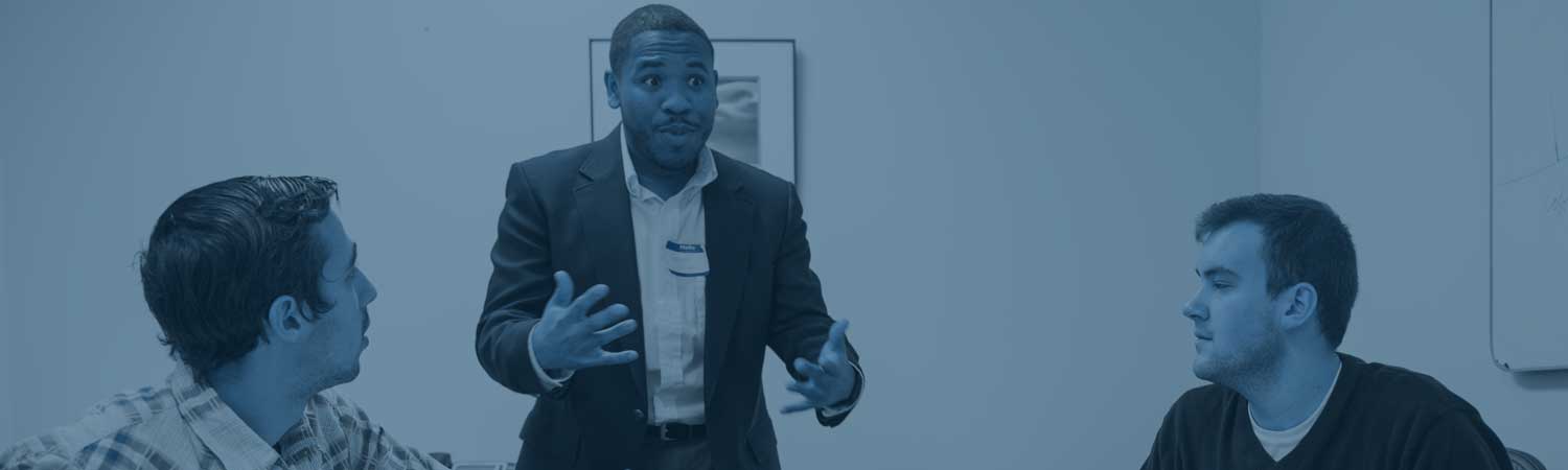 Porfessor speaking to a group of students