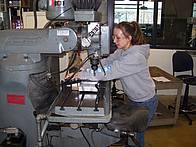 Student using engineering lab equipment.