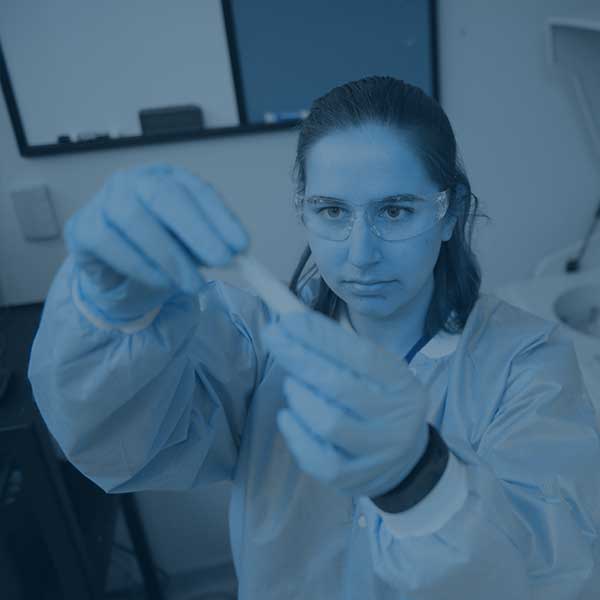 Student working in a lab with test tubes