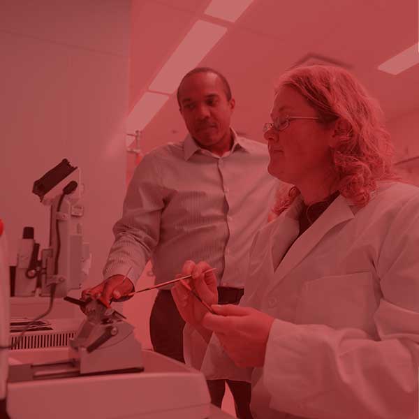 Student and professor at a microscope