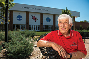 Hamilton with sign in background