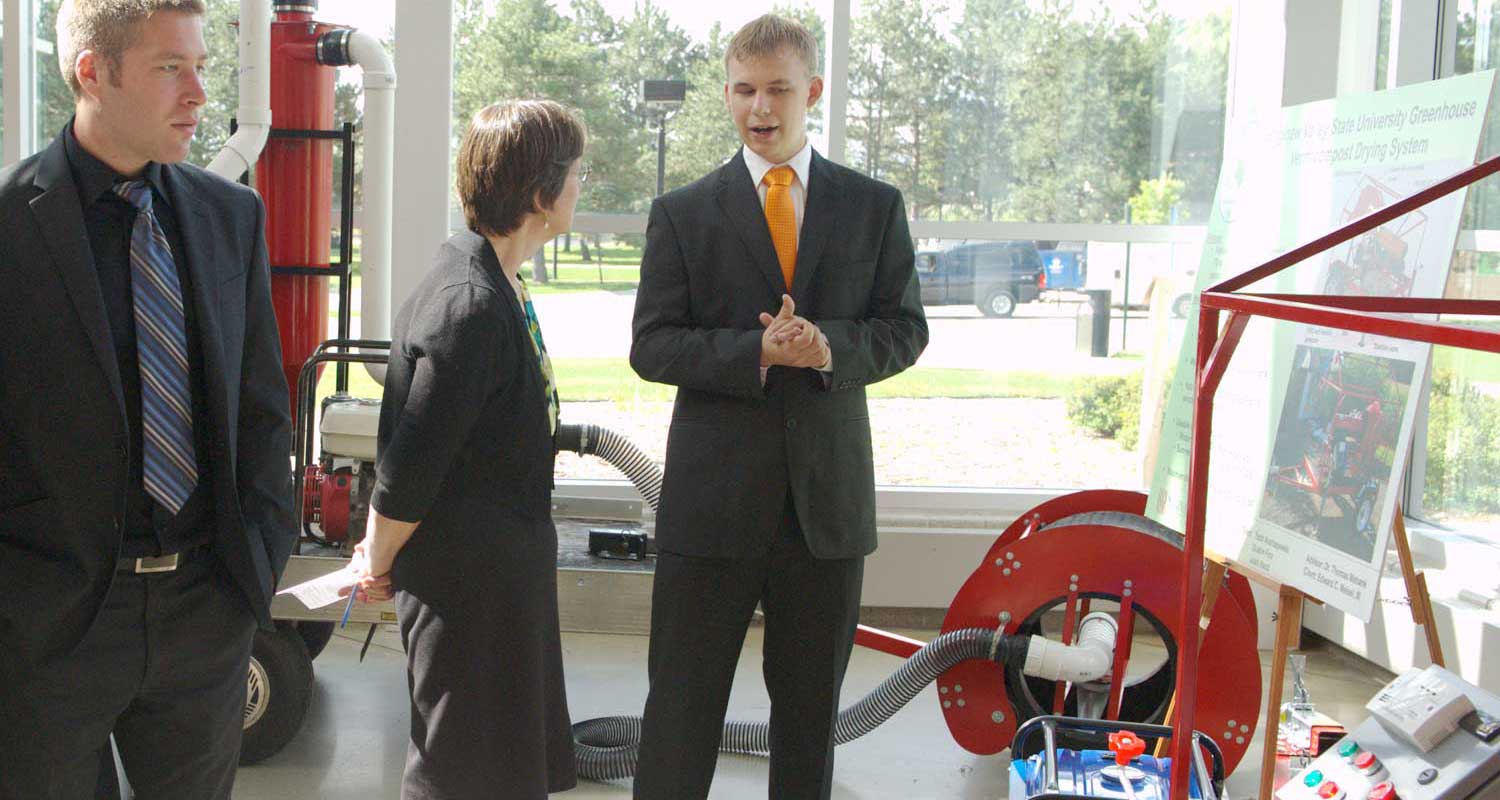 People in suits standing around