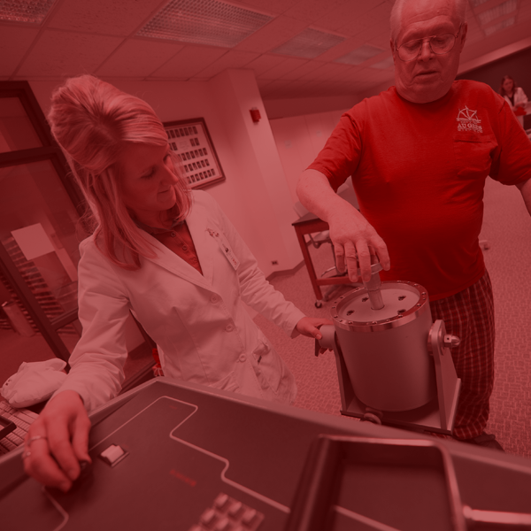 An OT works with a patient using lab equipment