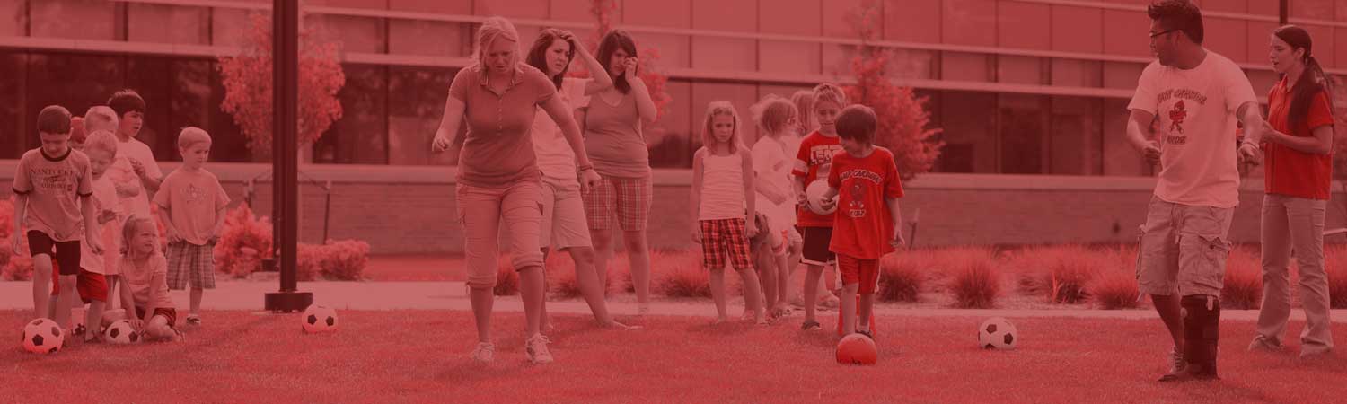 OT students work with children on a soccer field
