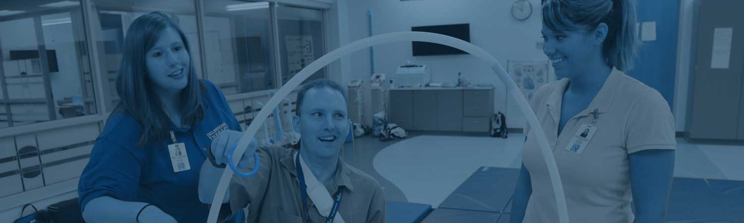 OT students working with a patient on hand/arm dexterity 