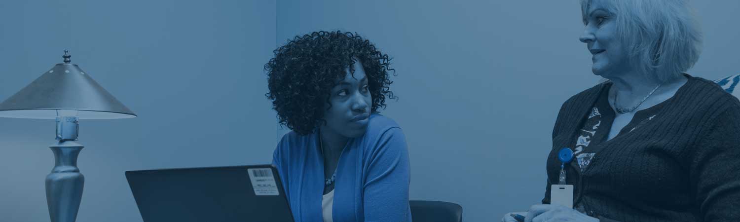 Women talking in an office setting