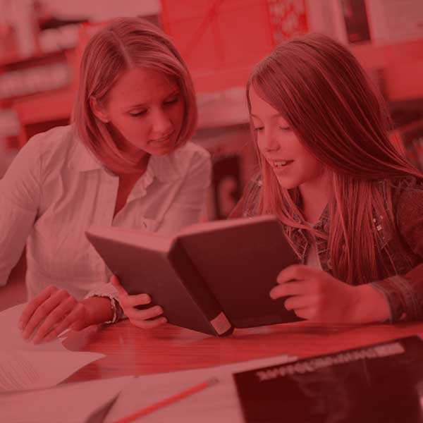 Student teacher helping a student with coursework