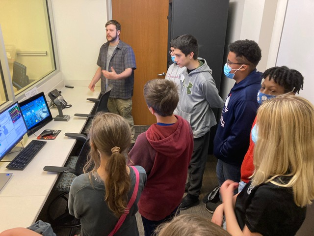 Students embracing technology with a STEM Professional.