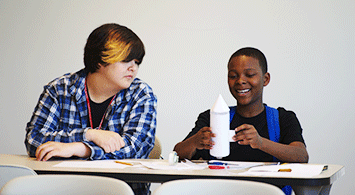 Kids working together on a mini rocket.