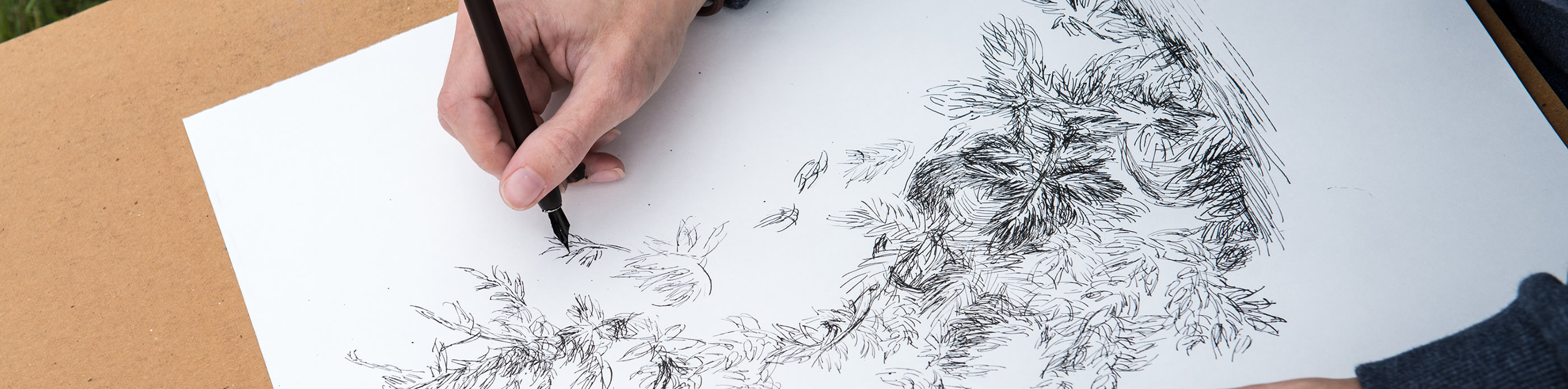 Student drawing with ink