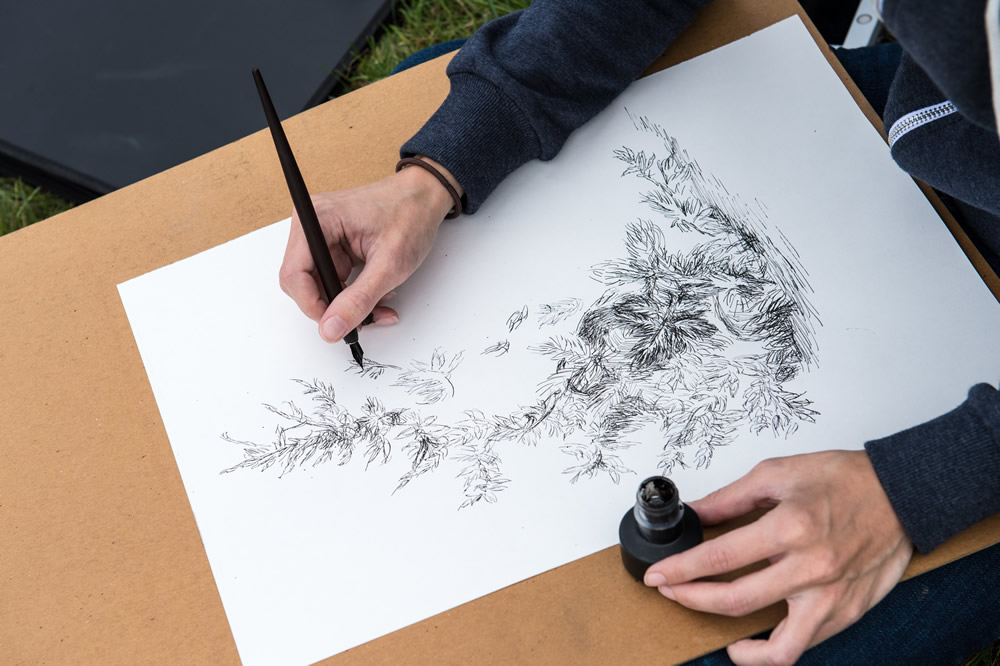 Student drawing with ink