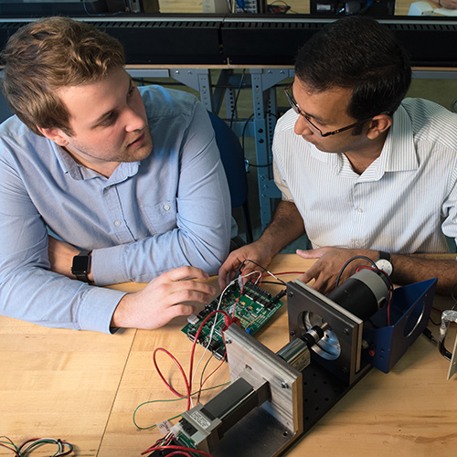 student with faculty in computer science lab