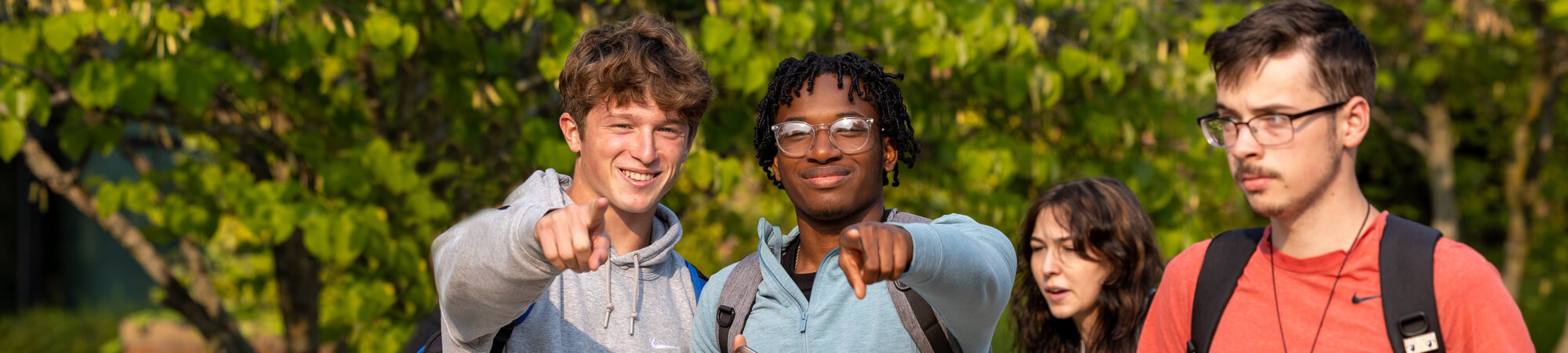 Students posing for photo while outside and walking