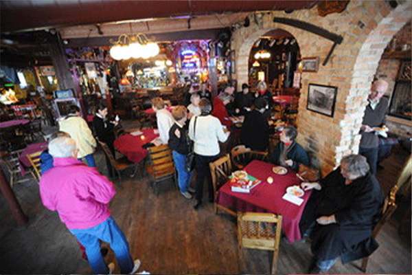 Several groups of people at a bar